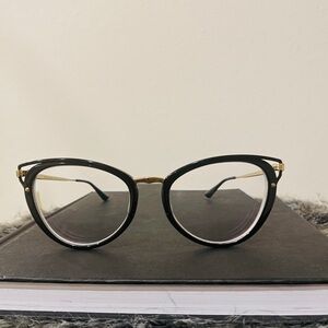 Stunning Prada eyewear featuring a sleek black and gold frame. #glasses #prada